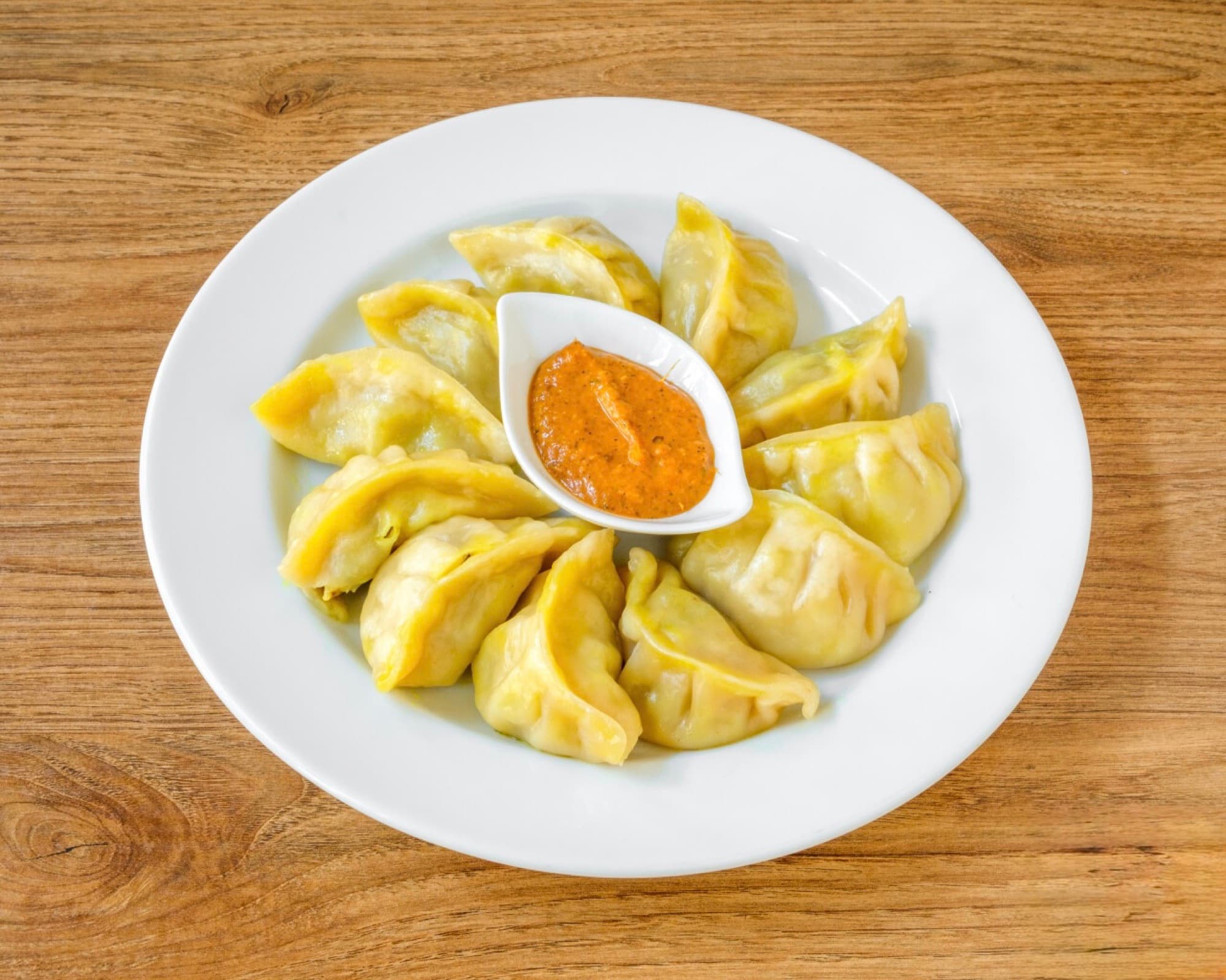 Freshly steamed momo dumplings with dipping sauce